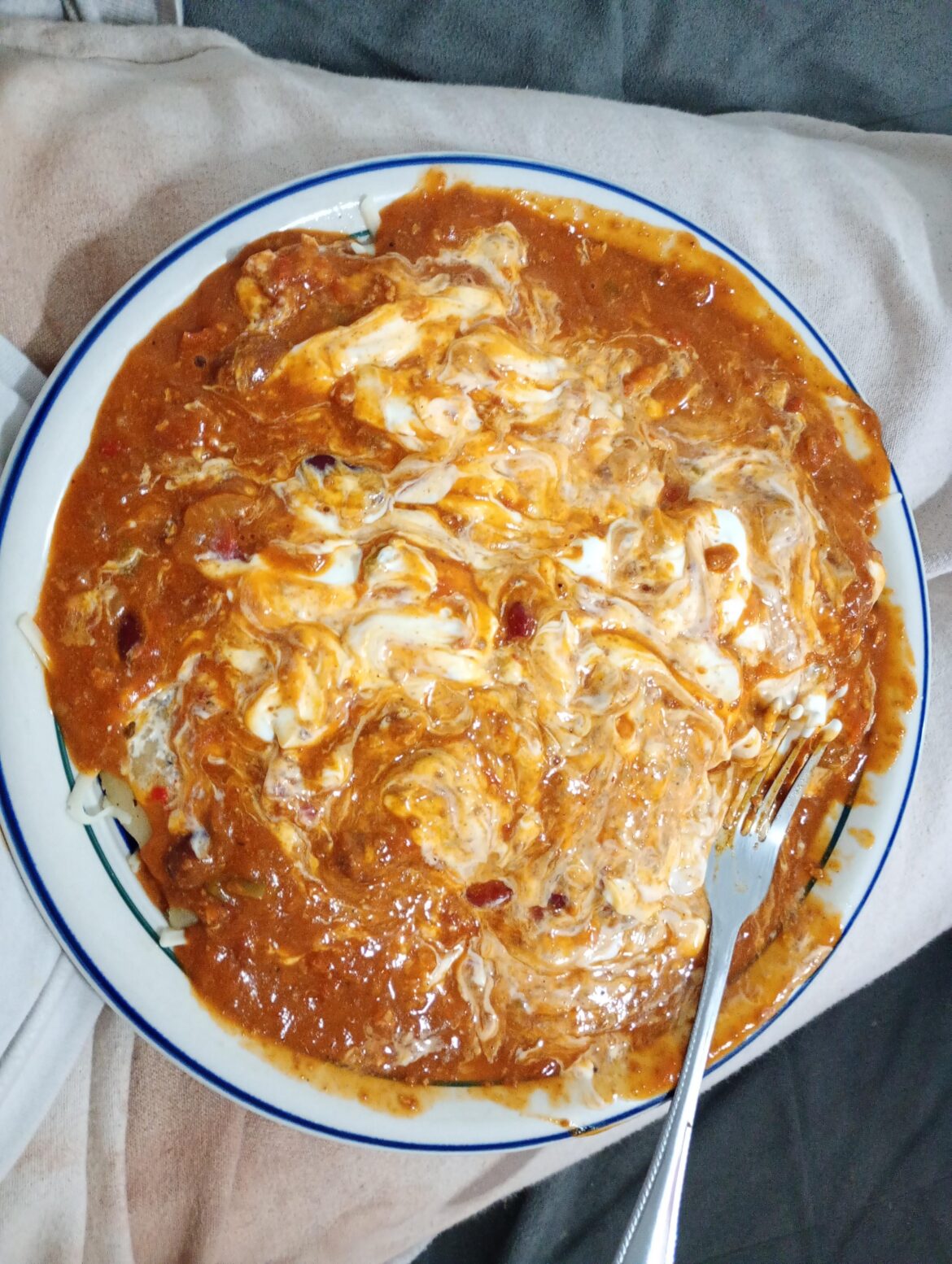 Some true drunken slop after 8 beers, Pierogi's covered with canned chili, mozzarella cheese, and sour cream