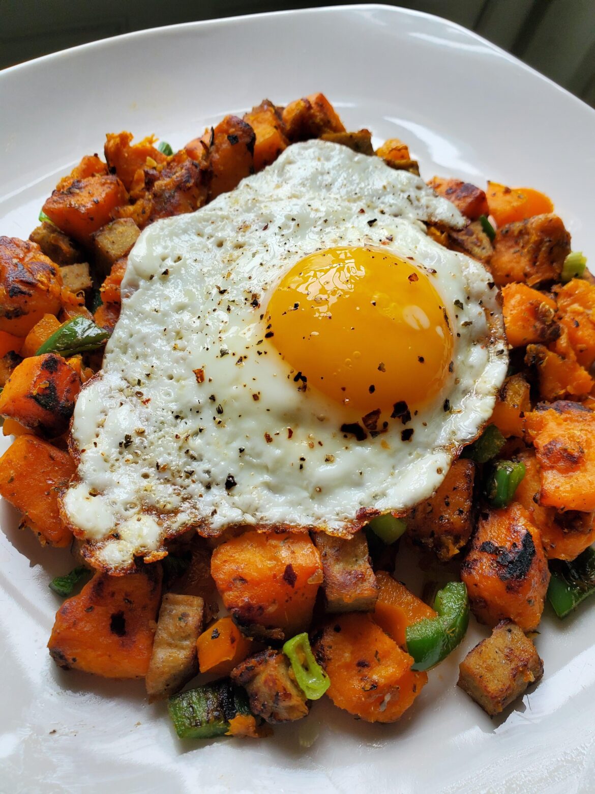Made a quick breakfast for lunch turning a baked sweet potato and sausage patty into hash topped with egg.