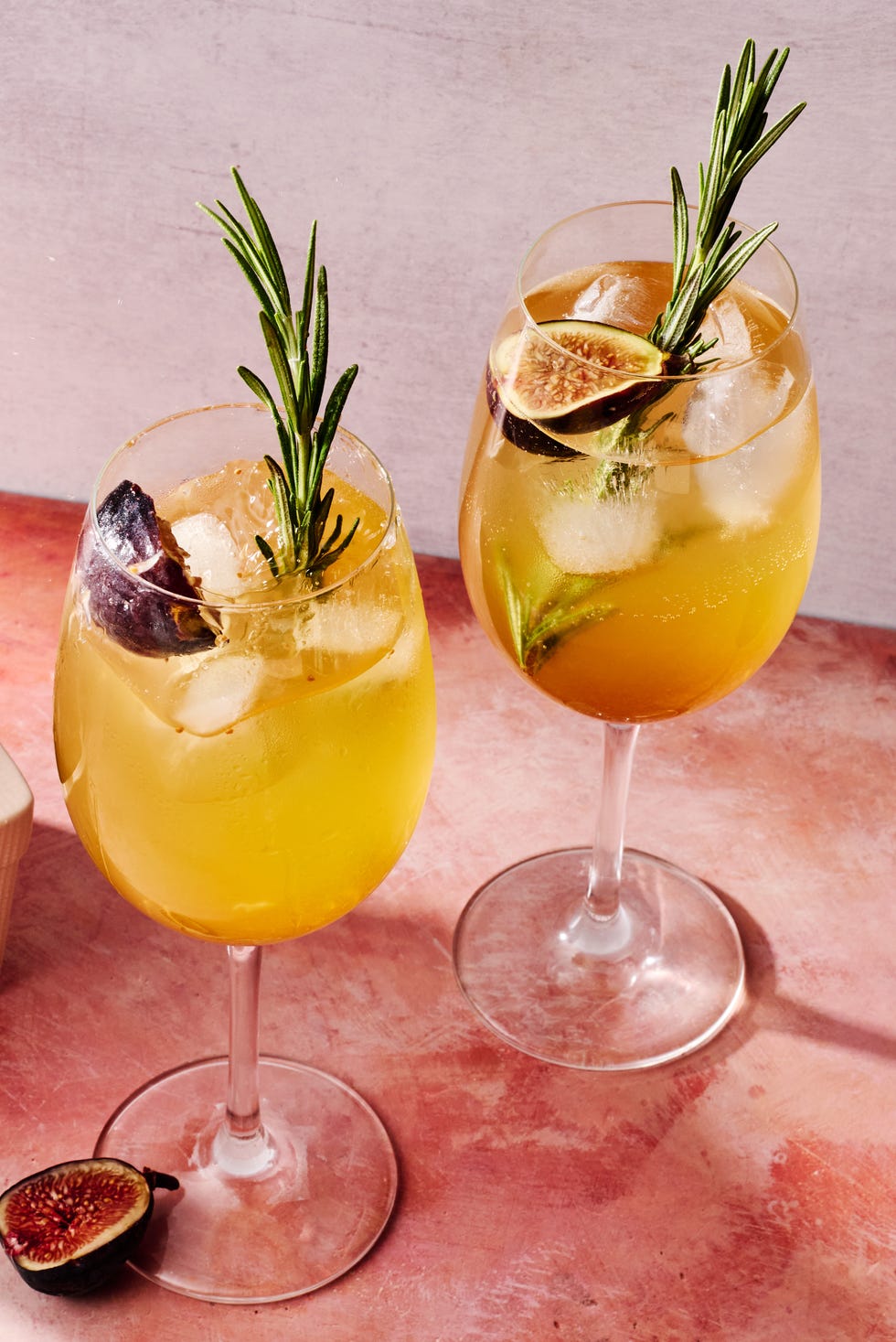 figgy spritz cocktail with a fig and rosemary garnish