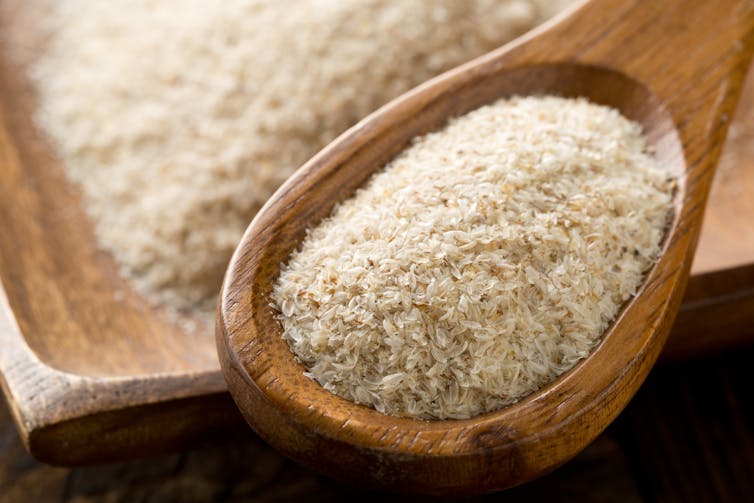 Heap of psyllium husk in wooden spoon