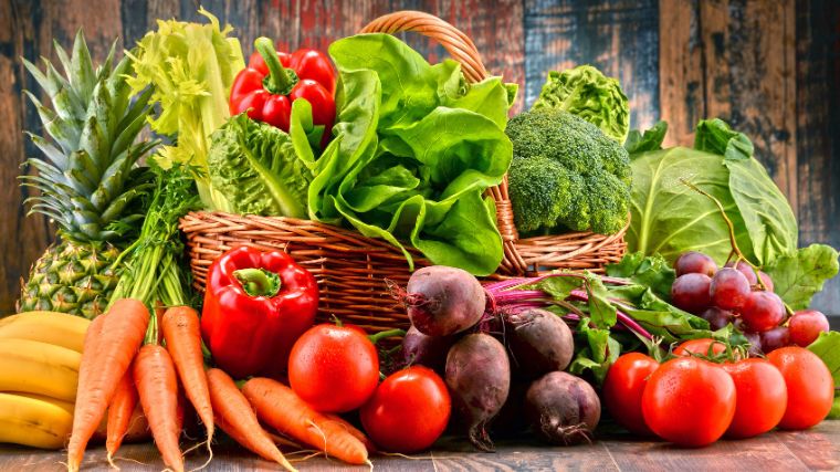 Fresh fruits and vegetables on a wooden counter.