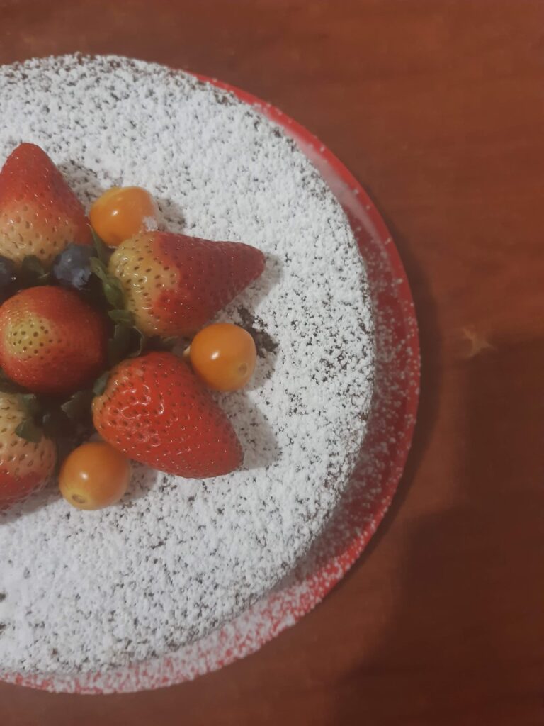 a cake made with lots of love and lots strawberrys.