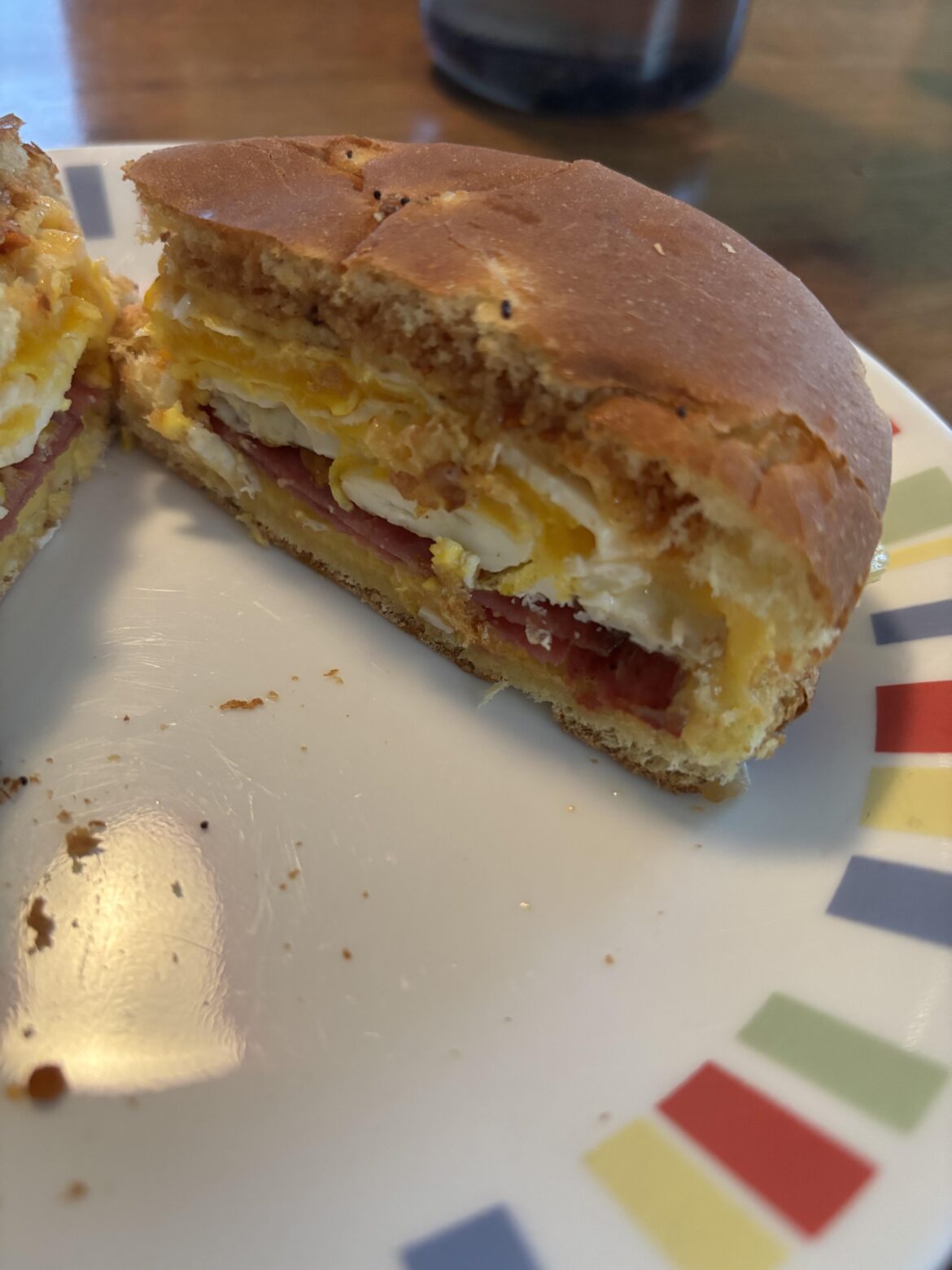 Two eggs, two slices American cheese, two slices fried salami, Cajun power garlic sauce and sichuan pepper sprinkle on toasted onion bun