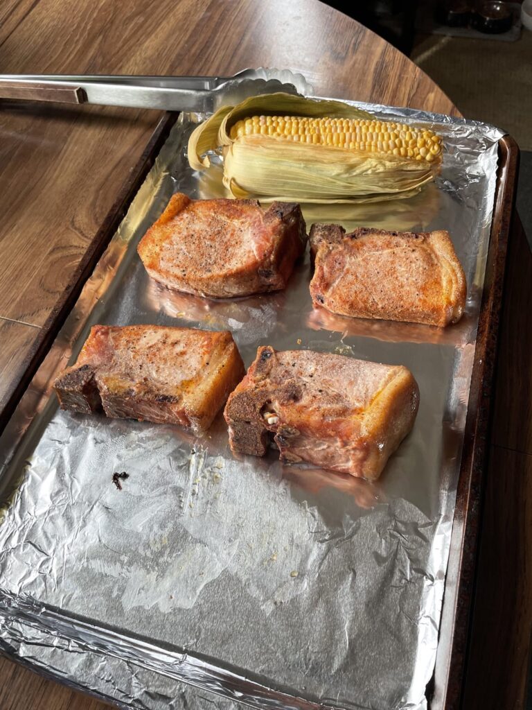 Rainy Sunday smoked bone in pork chops and corn