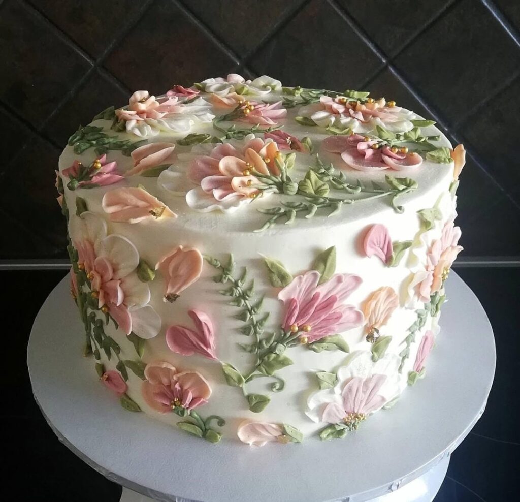 A buttercream pallet flower cake and matching cupcakes, something delicate and pastel for an elegant birthday party 🌸