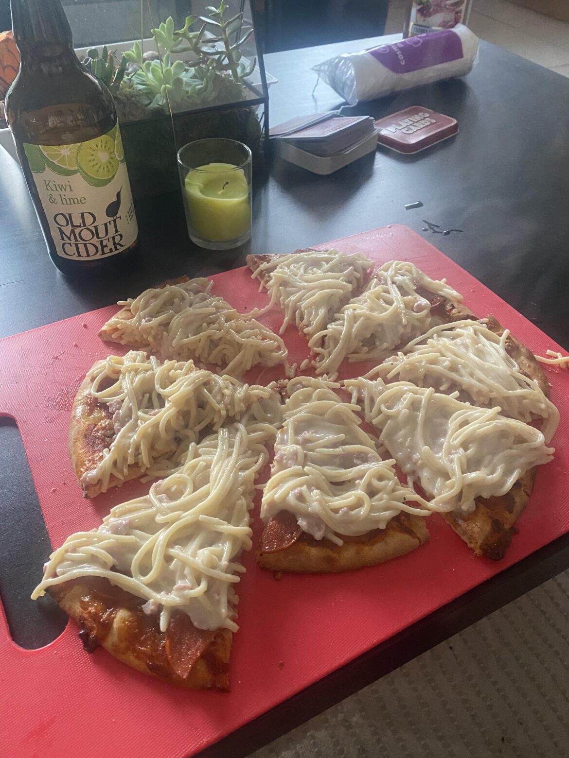 Pepperoni pizza with carbonara pasta slopped on top.