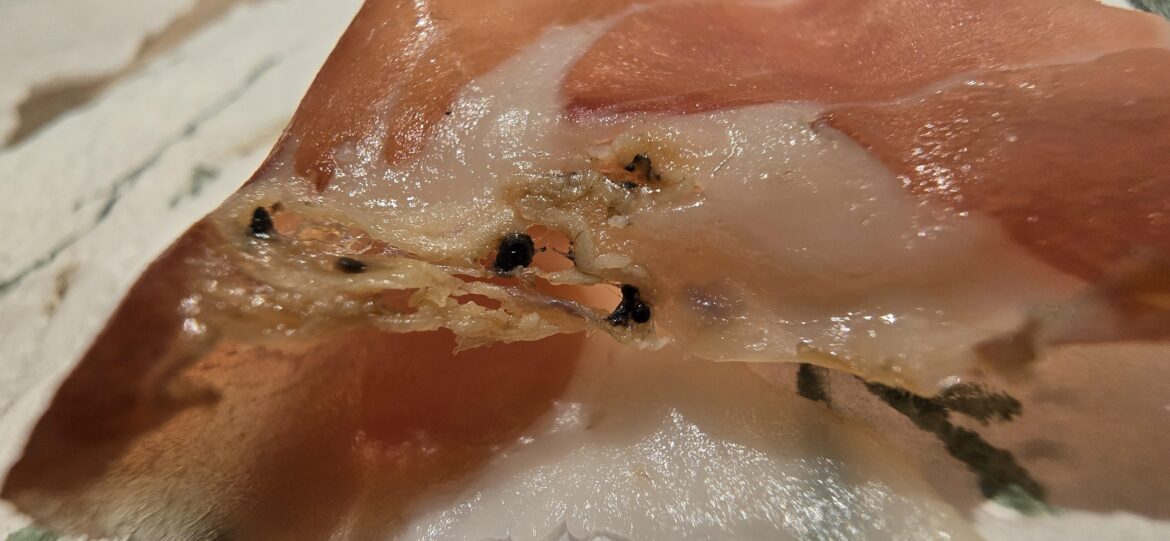 Any idea what these black bits are? It is in the fat part of some Serrano ham