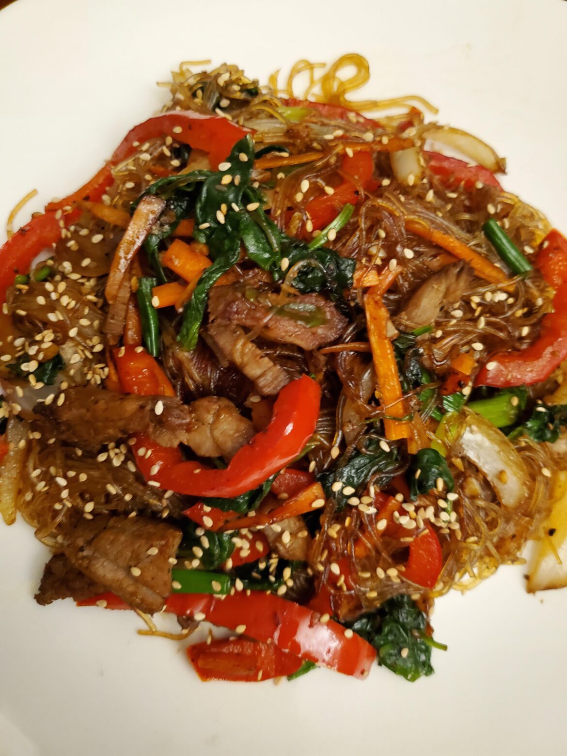 Japchae. Korean glass noodle stir fry with beef and veggies seasoned with soy sauce, garlic, and sesame oil.[oc]