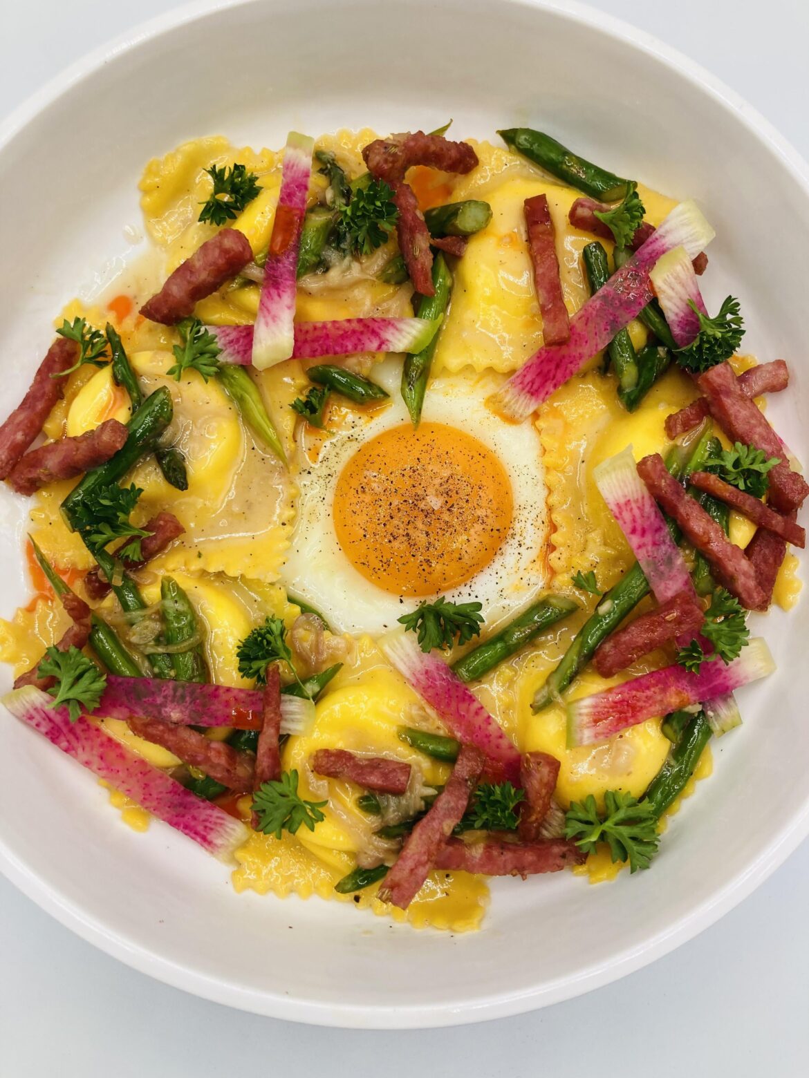 Lemon ricotta ravioli, crispy salami, asparagus, brown butter whey jus, watermelon radish, parsley