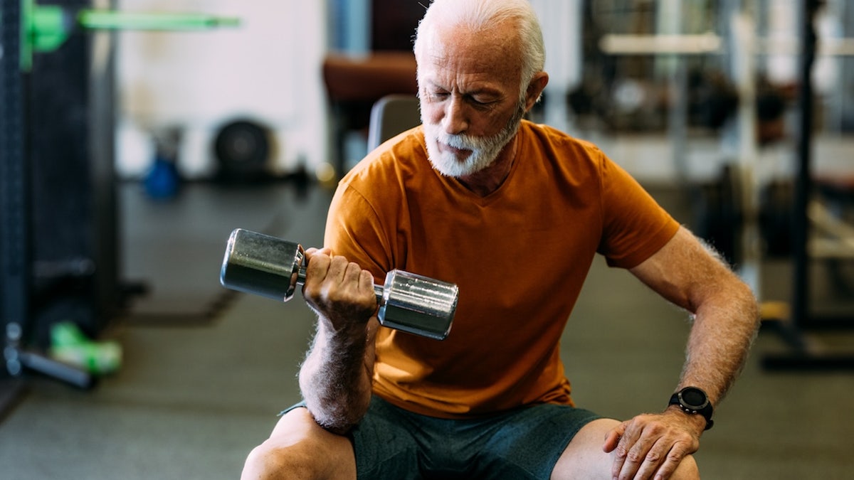 Older man lifting weights