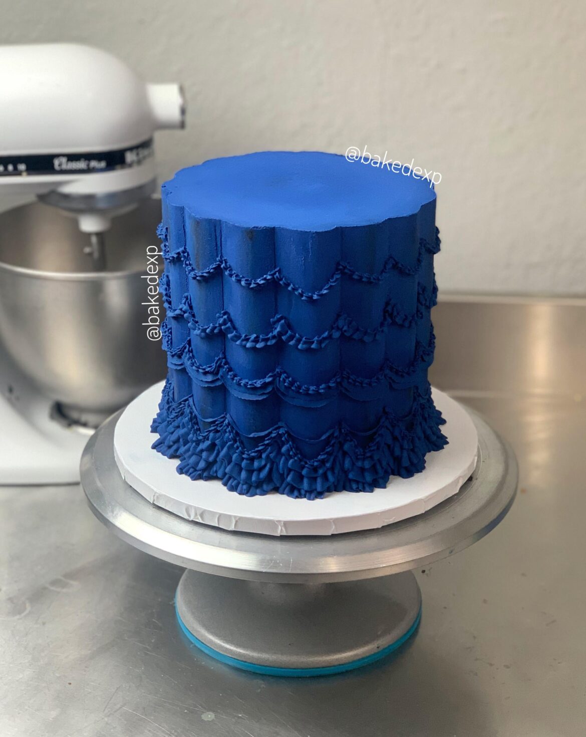 Trying out vintage designs on a scalloped cake.