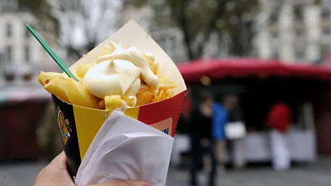 Richard Wareham Fotografie/Alamy It’s only in Belgium that fries are truly a meal unto themselves, piled into a paper cone with a touch of mayonnaise (Credit: Richard Wareham Fotografie/Alamy)