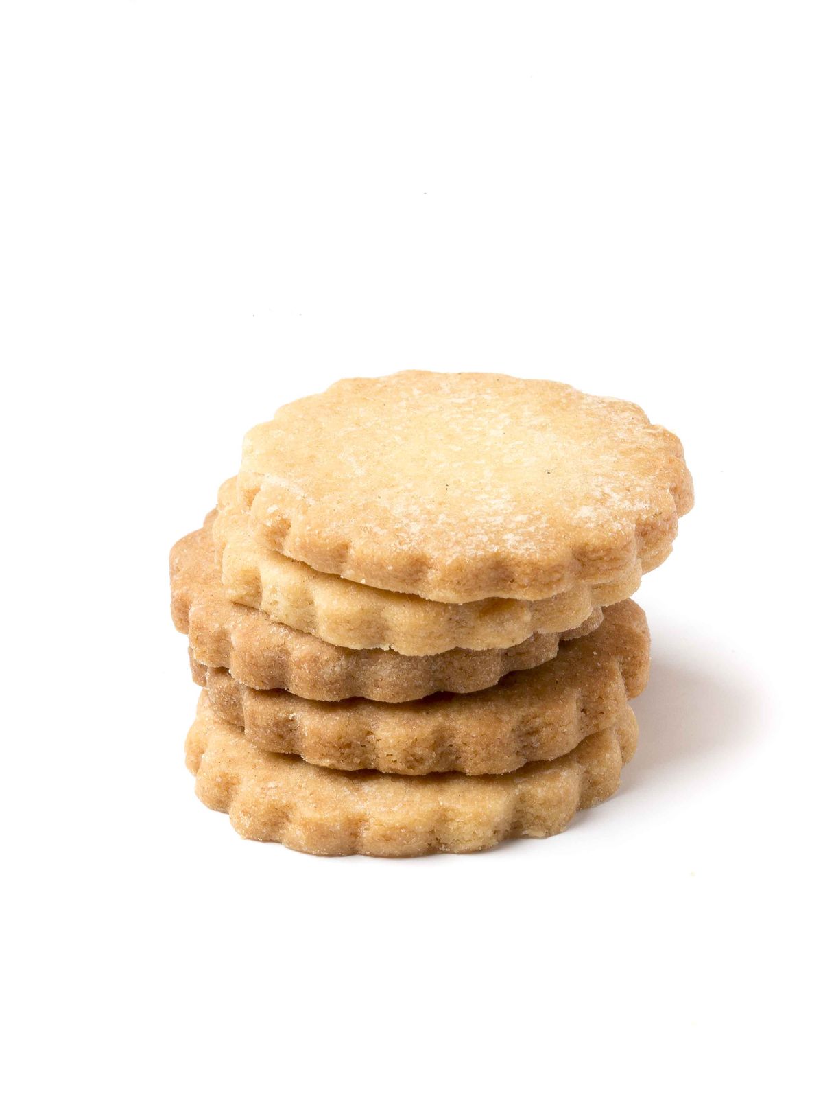 A stack of shortbread biscuits with a scalloped edge.