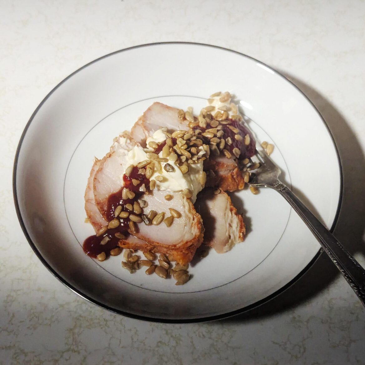 Tonight, we eat like kings! Pork loin, toasted sunflower seeds, mayo, and black pepper ketchup.