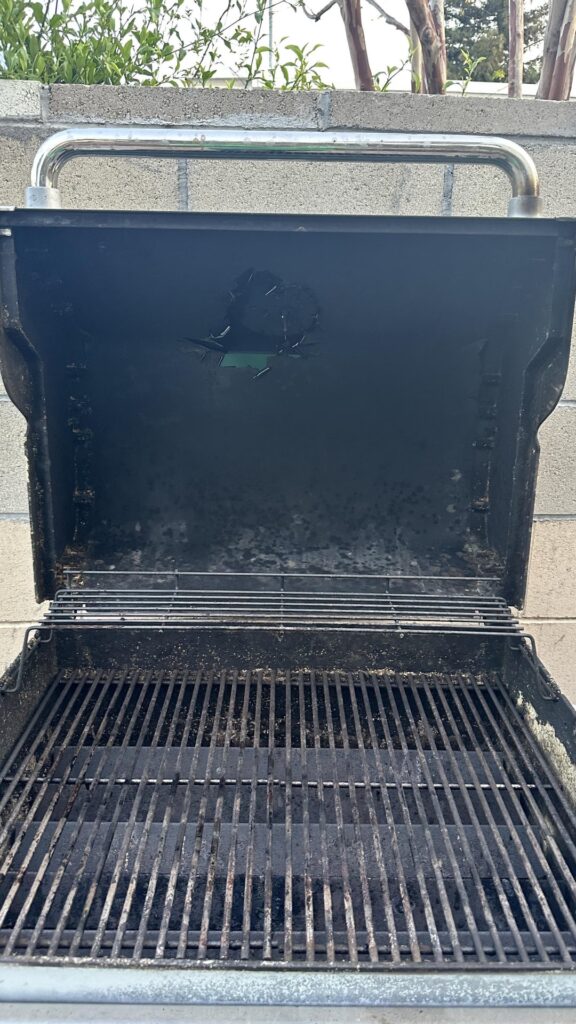 What is this plastic looking film on the bottom side of my grill lid?