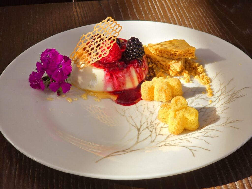 Buttermilk panna cotta, berry compote, honeycomb toffee, sugar cookie "bugs"