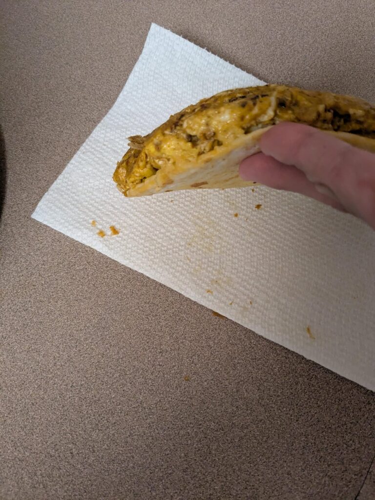 Mexican pizza omelette eaten fat man style. Tortilla with mozzarella cheese and then four egg omelette made with fly by jing chili oil. Eaten like one giant slice of pizza AKA fat man style. Tortilla was crisped up on the bottom.