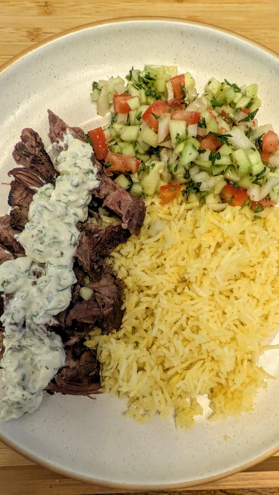 Slow roasted leg of lamb, cumin rice, cucumber salad, homemade tzatziki sauce.
