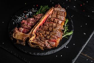 T-bone steak grilled beef Medium rare steak grilled in pieces with pepper and salt