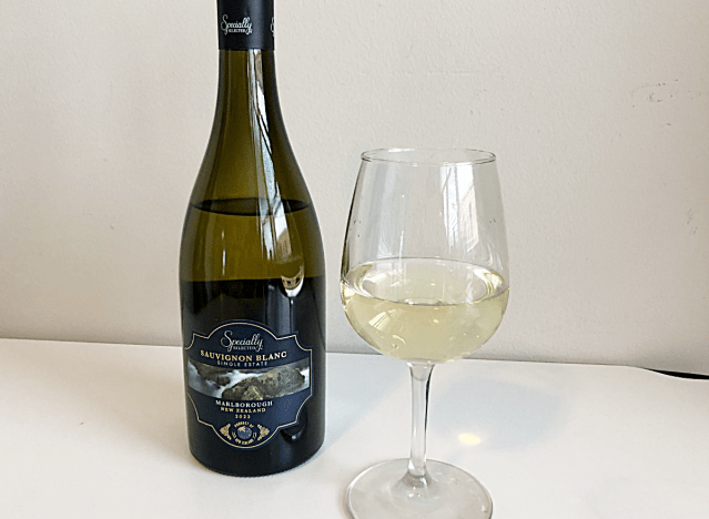 a bottle of sauvignon blanc next to a glass of white wine