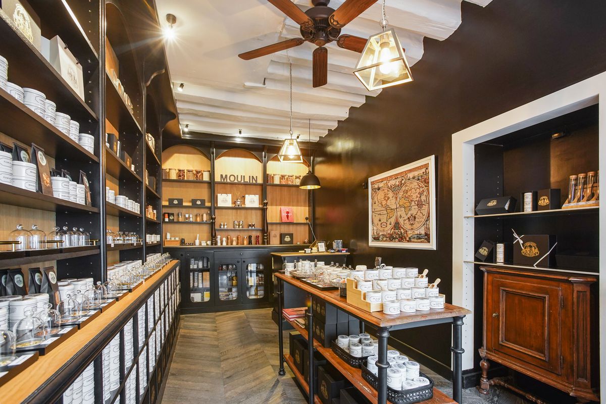 The interior of a shop with a table at the center and shelves lined with elegant packages
