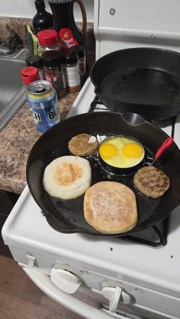 Two egg, two sausage one pan English muffin sandwich with 2 American cheese at 3am with Busch