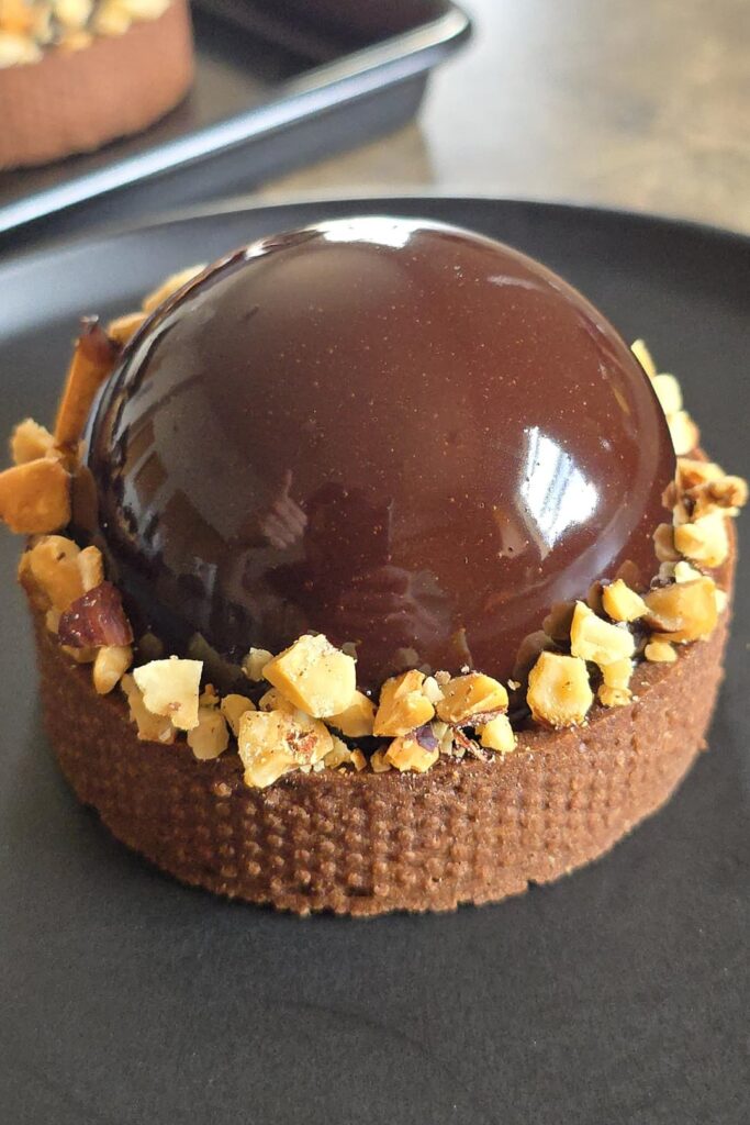Chocolate mousse, caramel and hazelnut tart