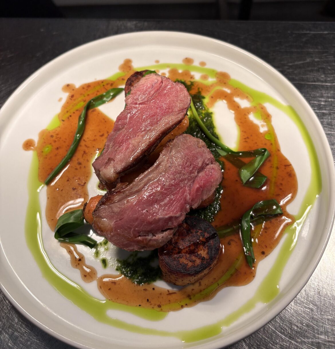 Lamb rump, sweet potato fondant, roasted normandy sand carrot with wild garlic salsa verde and a port sauce