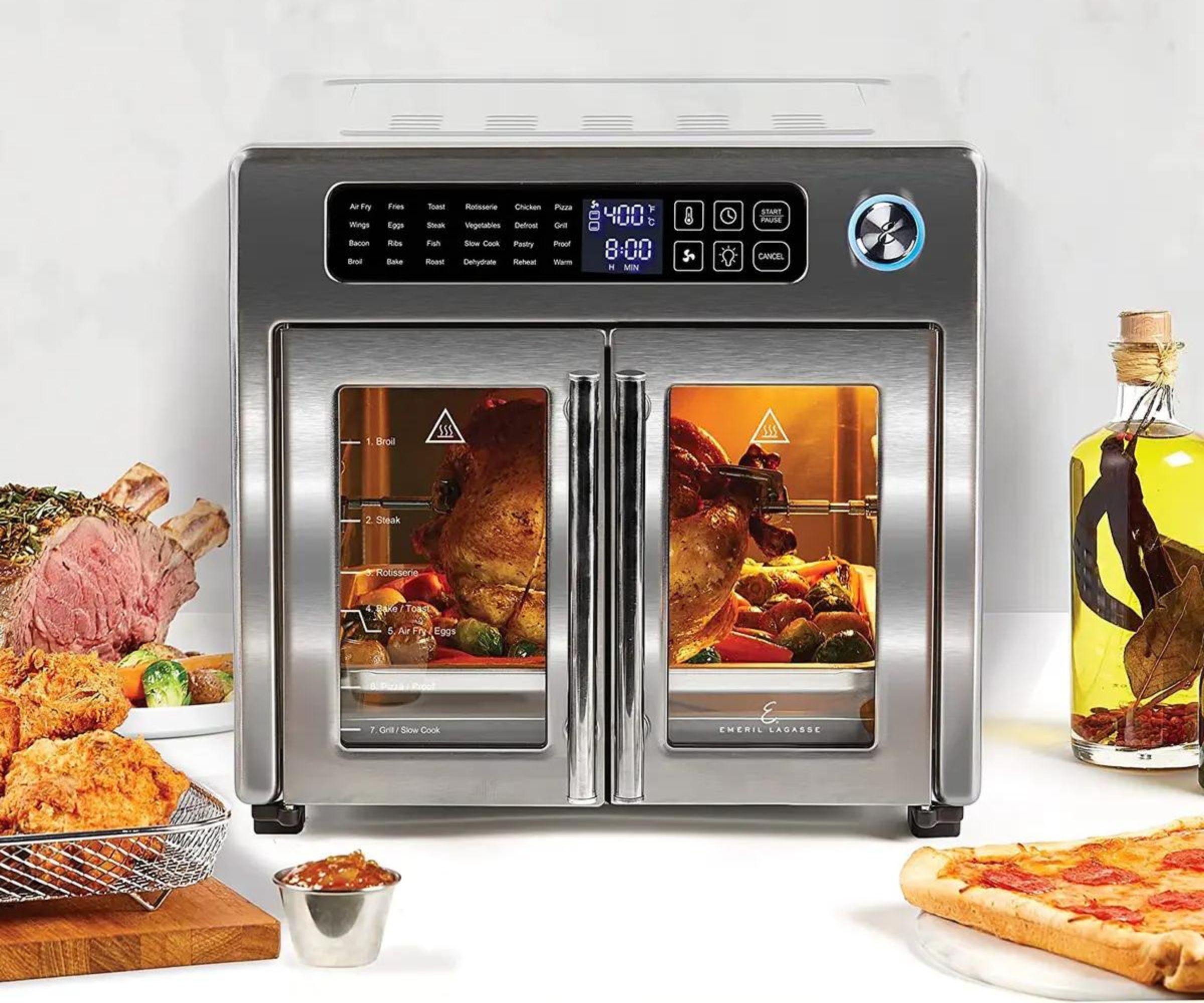 French door air fryer on rotisserie mode, roasting a chicken, resting on a kitchen counter.