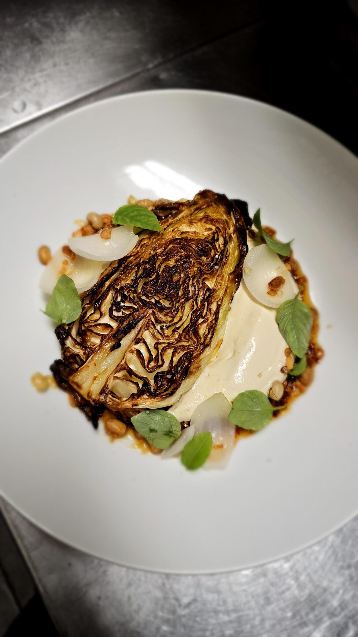 Charred baby hisbi cabbage, silken tofu mousse, chili crisp, pickled Cipollini onions, Thai basil and roast soy nuts