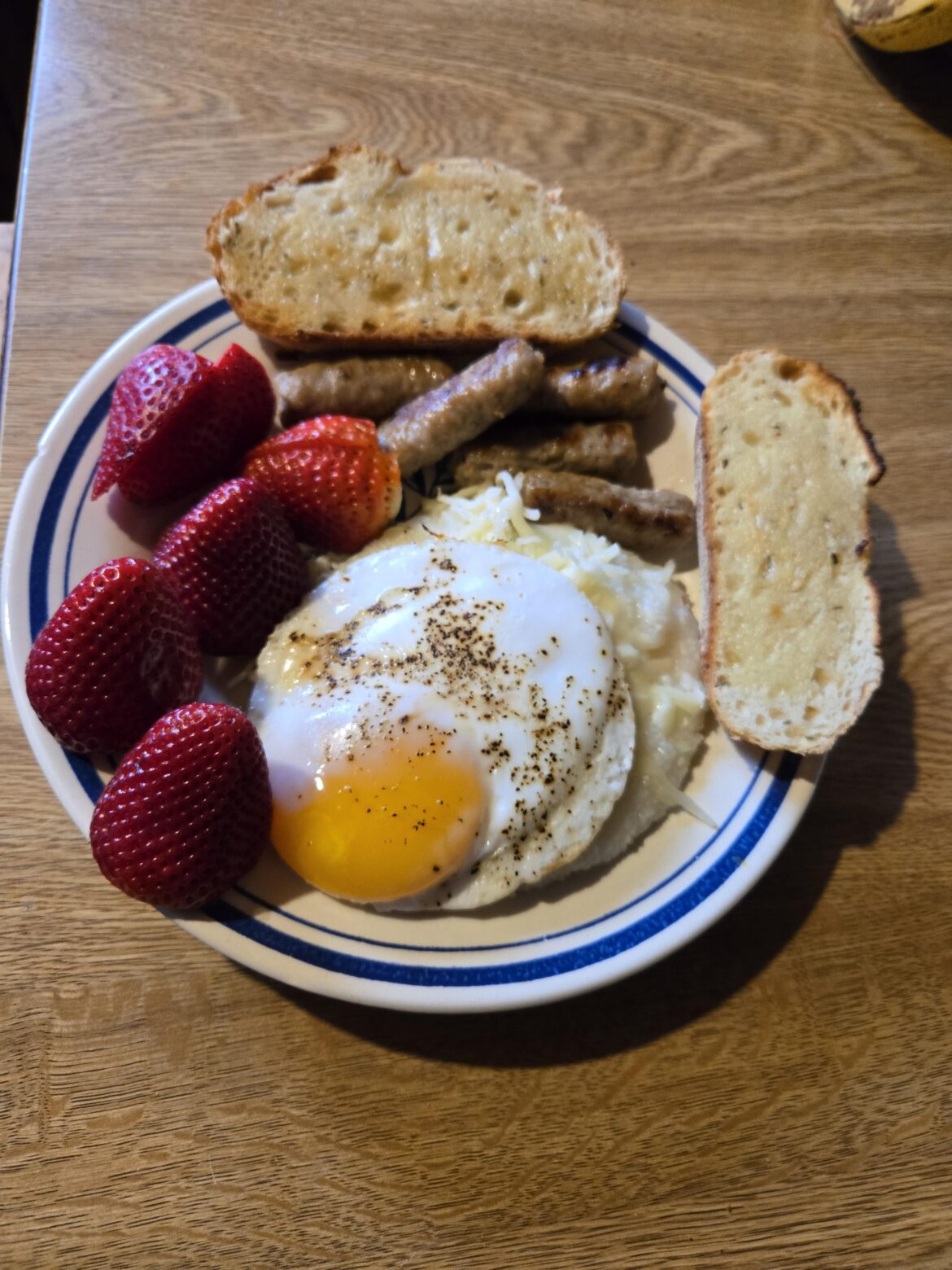A duck egg on cheesy grits with some extras
