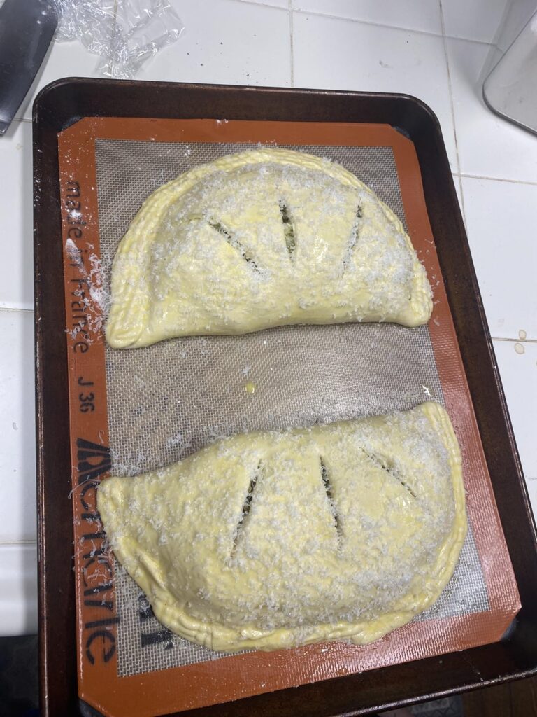 Chicken, pesto, and caramelized onion calzones for the wife and I.