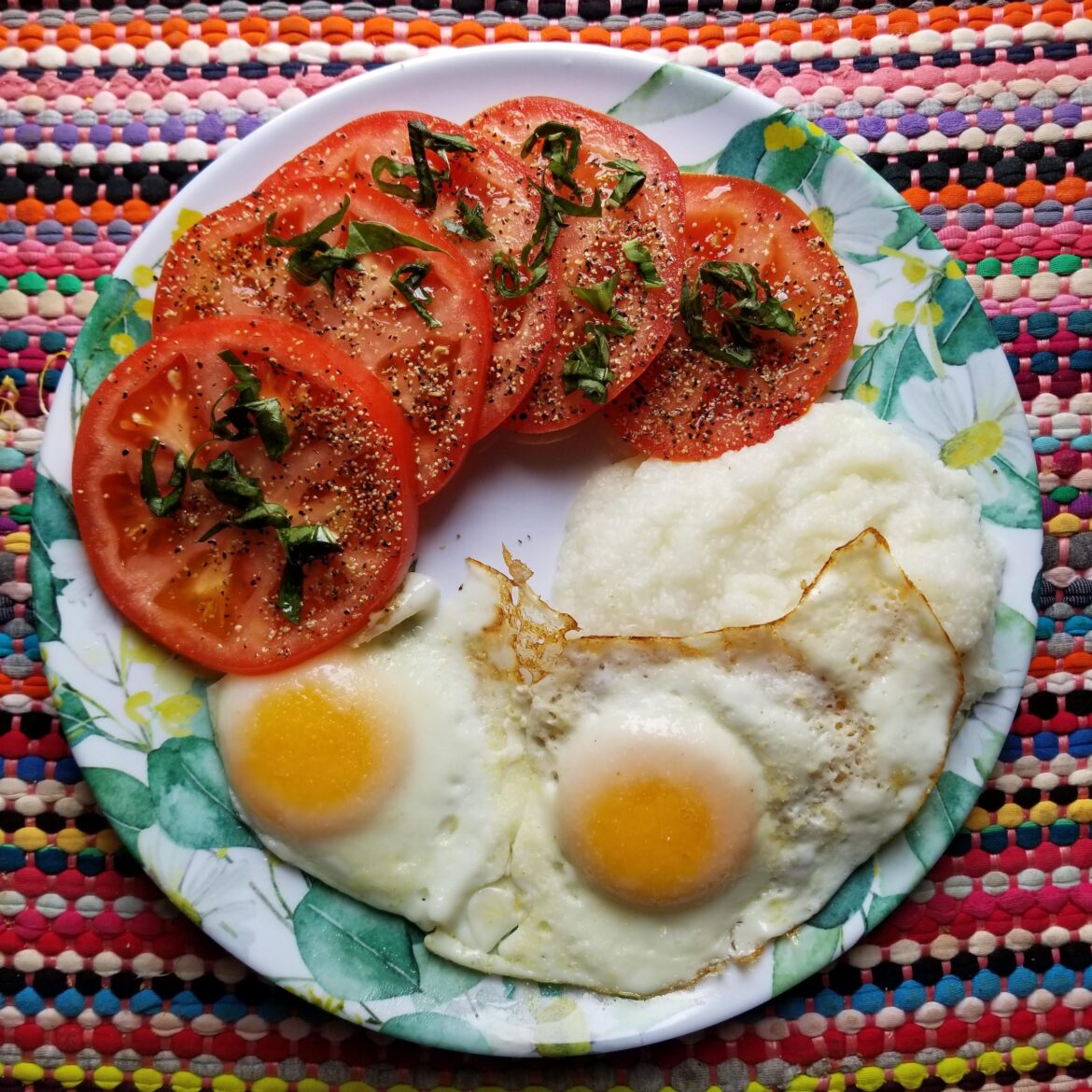 Today's Breakfast: Two Fried Eggs With a Side of Grits and Sliced Beefsteak Tomato ~ 410 Calories