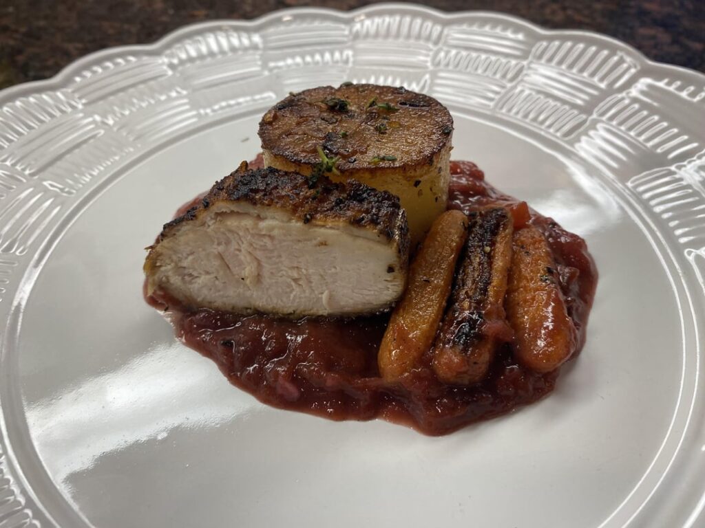 Seared chicken, roasted honey thyme carrots, fondant potatoes and a plum sauce. Seared chicken, roasted honey thyme carrots, fondant potatoes and a plum sauce.