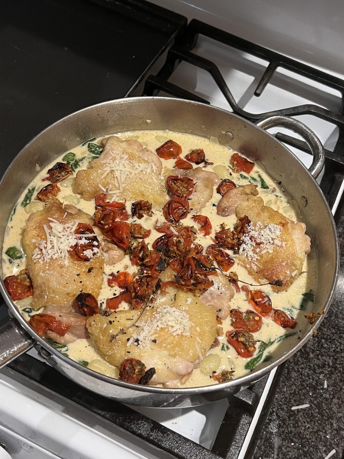 Chicken and gnocchi with roasted tomatoes and spinach in a dijon mustard sauce. Added romano