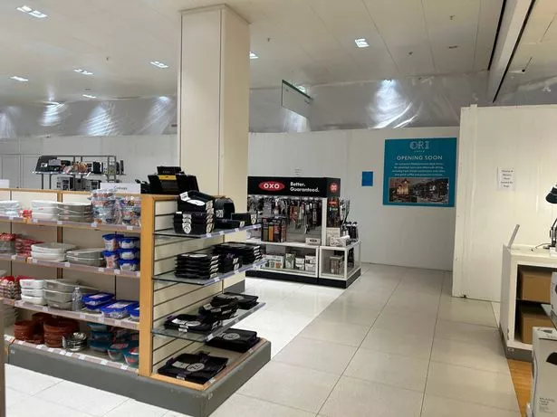 Photo shows sign advertising opening of Ori Caffe in John Lewis