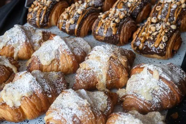 A tray of croissants, including some layered pain au chocolat