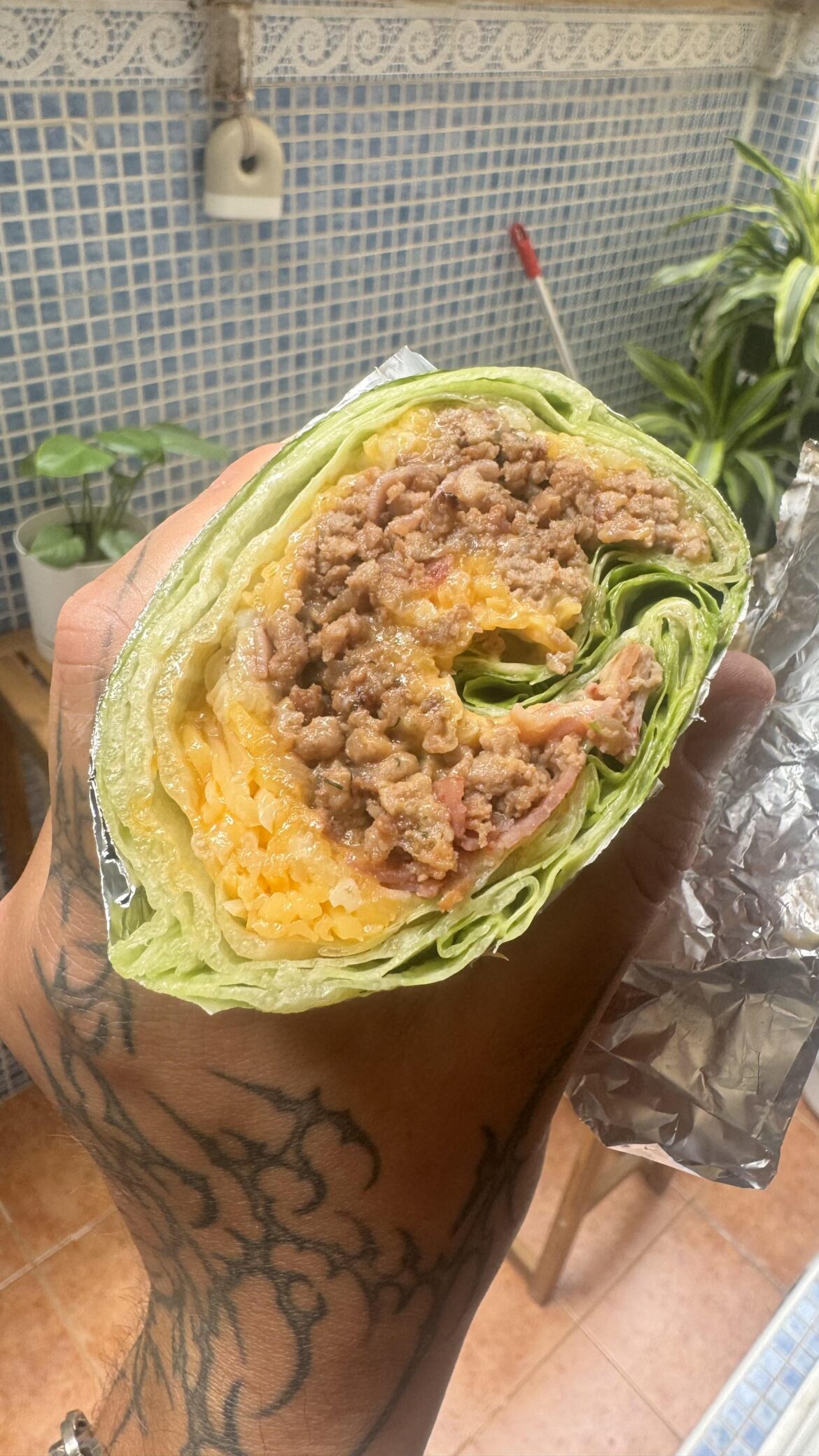 Keto burrito burger lettuce wrap (minced beef, bacon, shredded cheese, duck foie-gras, onions, tomato & yogurt sauce)