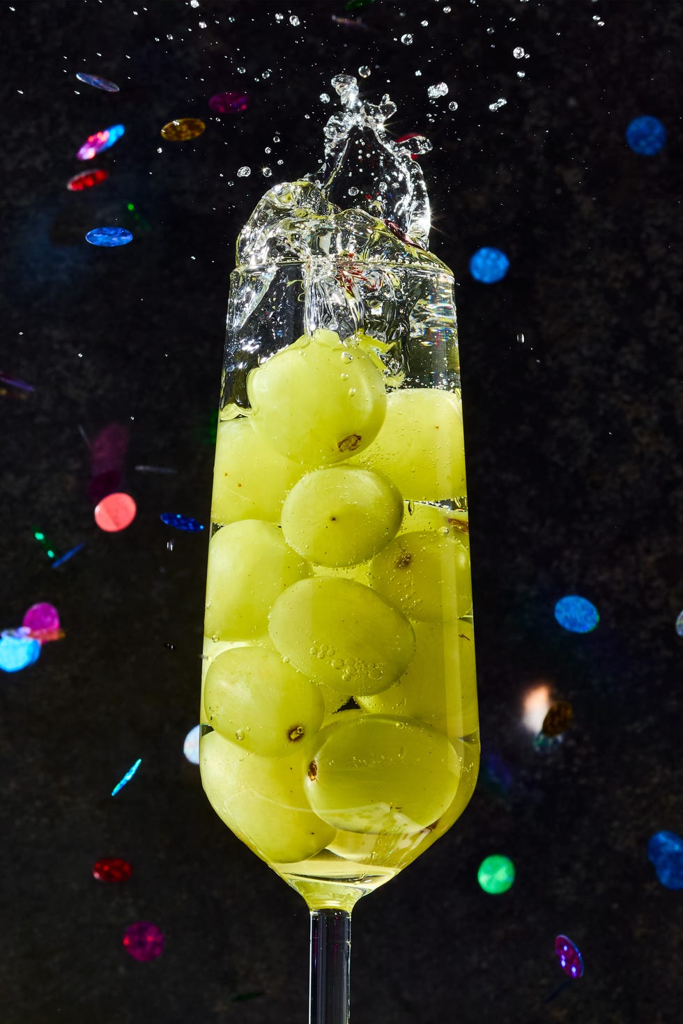 glasses of champagne filled with 12 green grapes