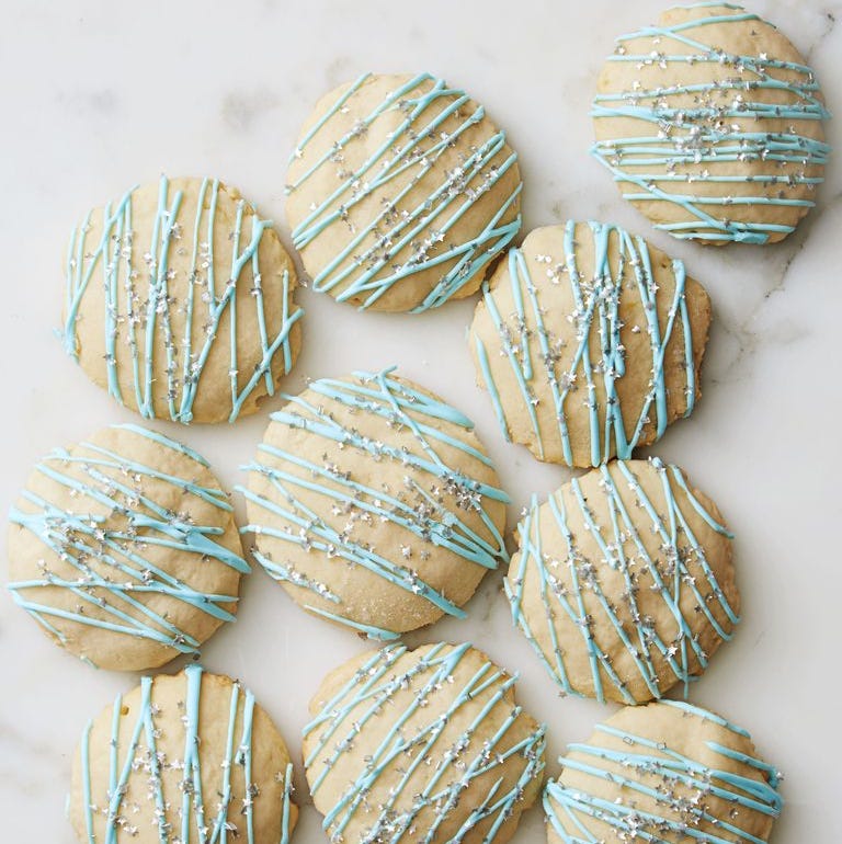 lemon ricotta cookies with blue icing drizzled on top