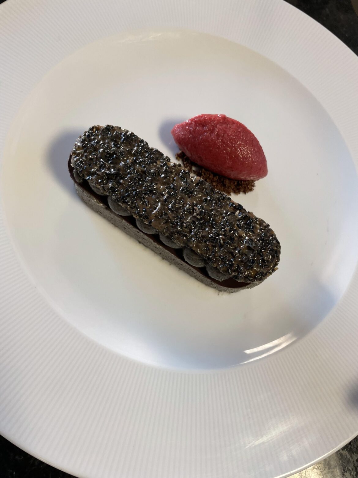 iced black sesame parfait cherry jam insert , tempered chocolate, black sesame cremeux , black sesame tulie, coco crumb cherry sorbet