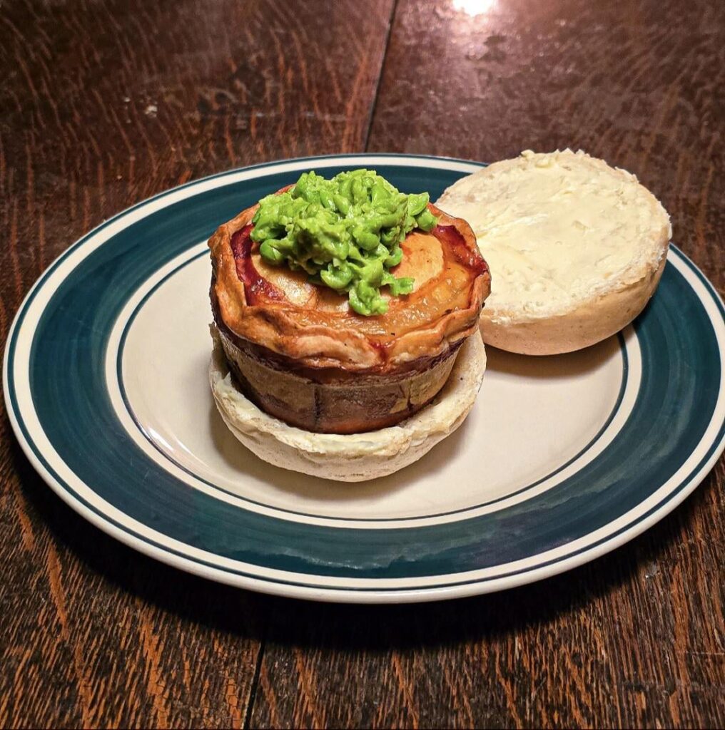 Lenten Wigan pie barm: Norwegian cod & potatoes w/ leek and pepper gravy in rosemary & thyme hot water pastry w/ mushy peas on fresh baked roll