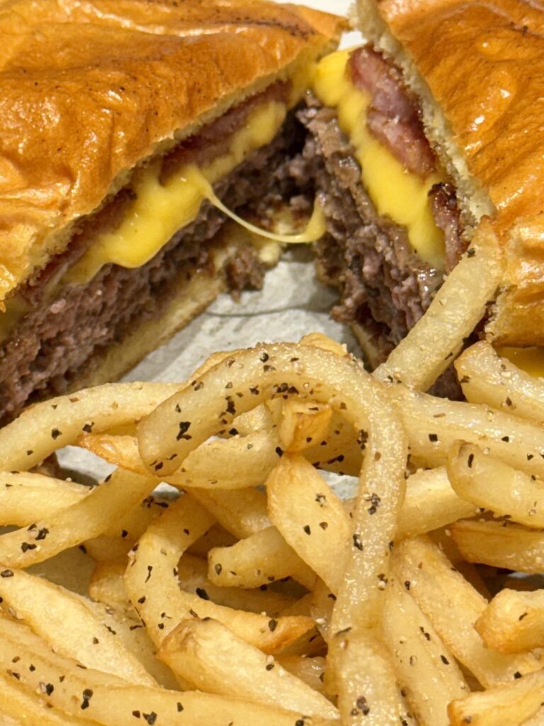 Mesquite Burger with Maple Bourbon Bacon and Double American Cheese on Duck Fat–Toasted Brioche, Served with Beef Tallow–Fried Fries, Cracked Pepper & Himalayan Salt