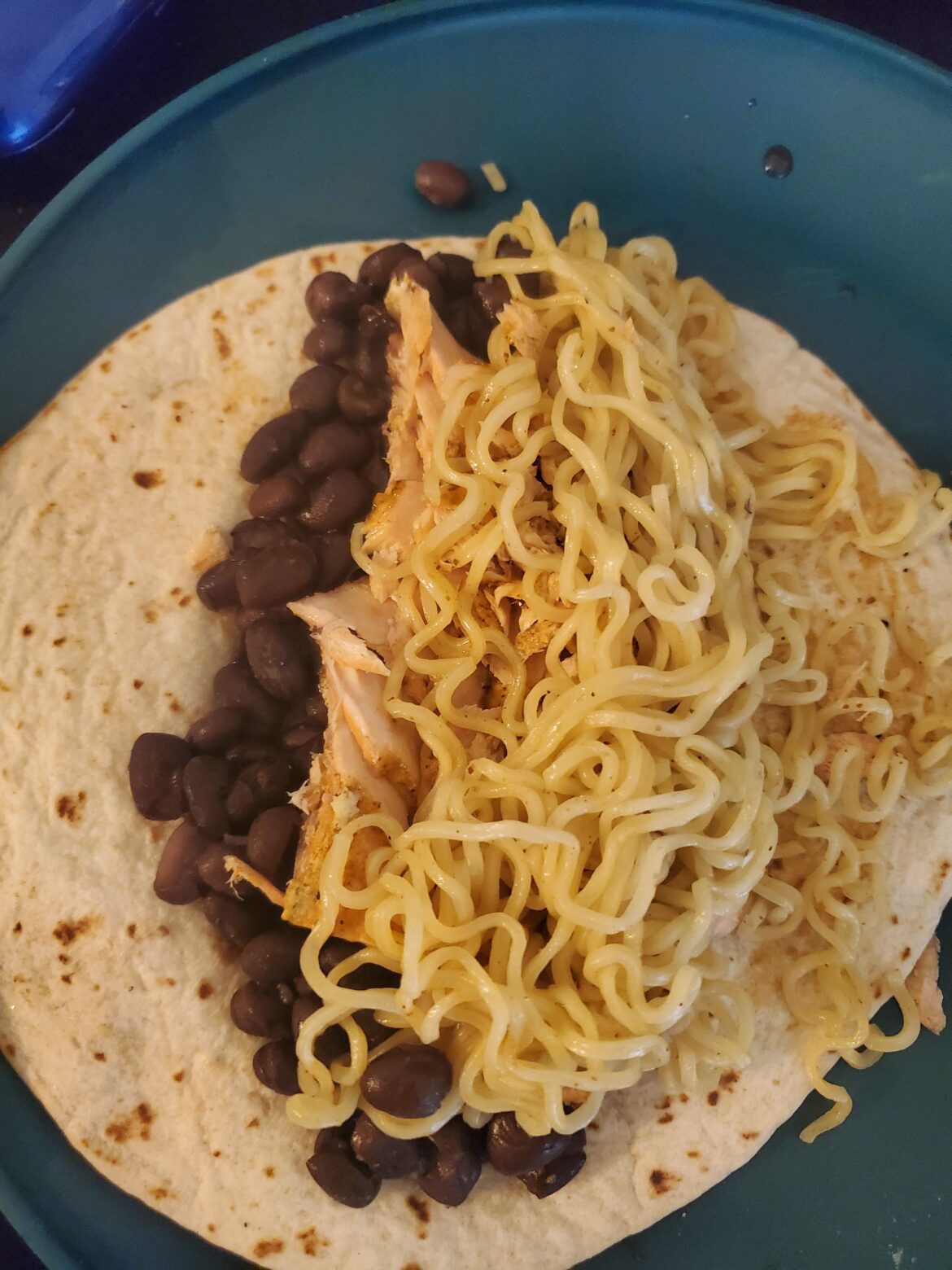 black beans, salmon, and ramen on a tortilla. wtf do i even call this