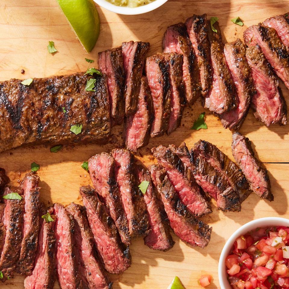 sliced carne asada with pico de gallo, limes, and salsa verde