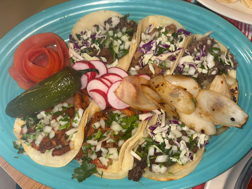 Taco plate with grilled steak, pastor (Marinated Pork), chicken, cow tongue and tripe tacos