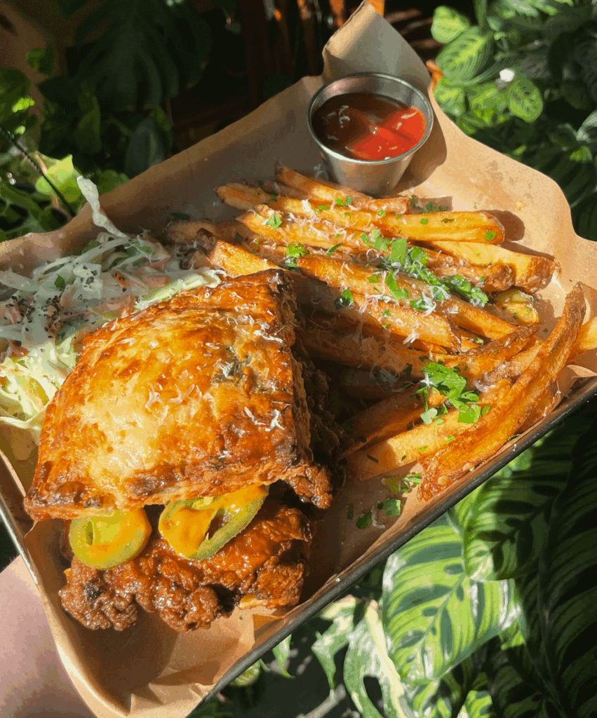Hot honey fried chicken on a jalapeno cheddar biscuit. Plus homemade fries + slaw on the side.