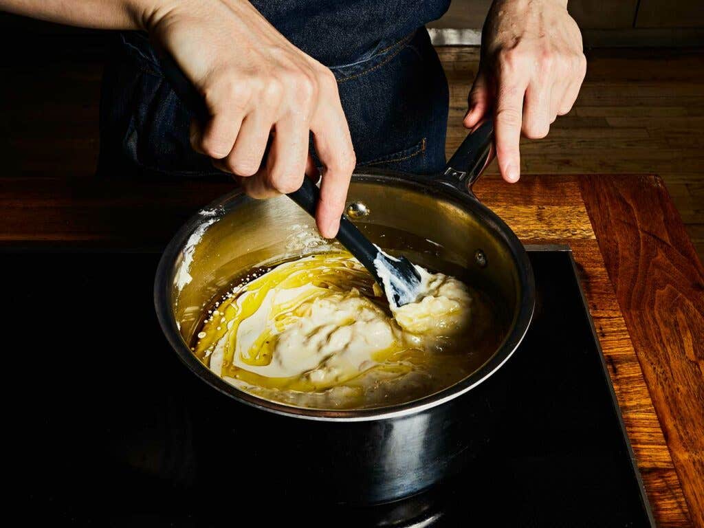 Beating the liquids into the base to create an emulsion.