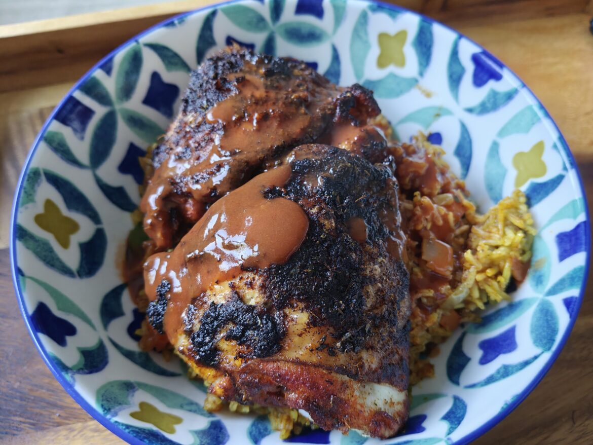 Smoky Cajun chicken with a golden vegetable pilaf