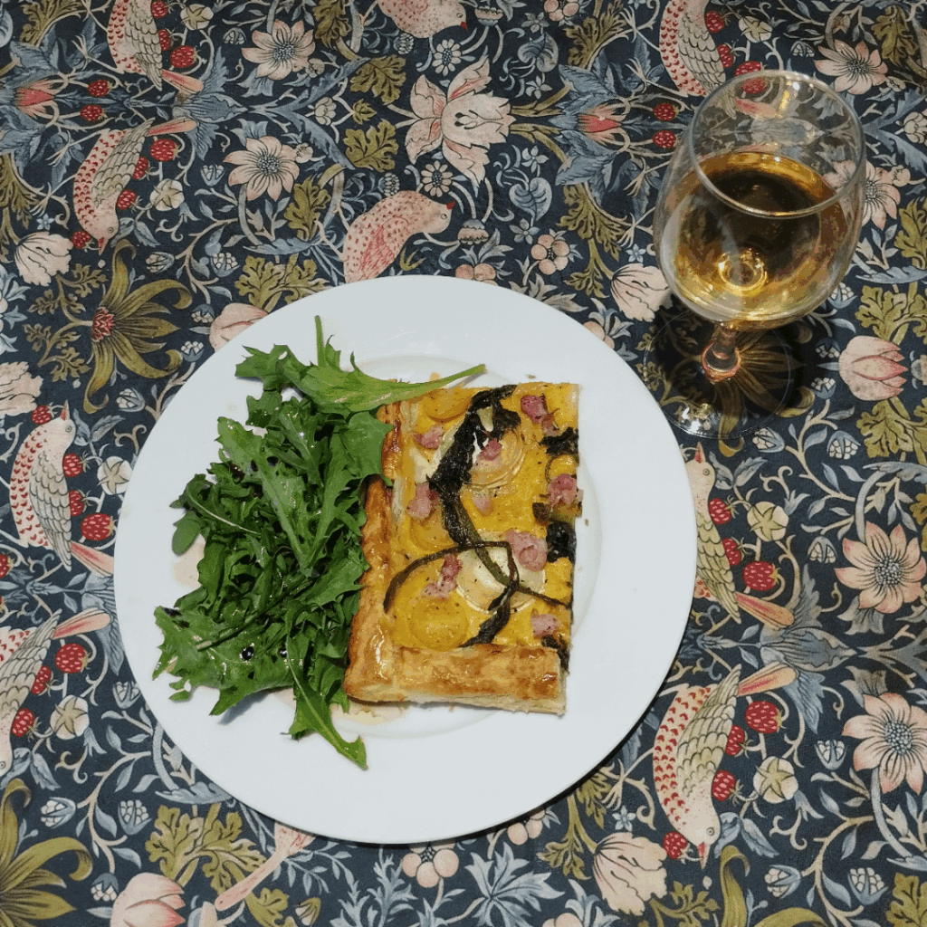 Goats cheese, tomato, pancetta and hogweed shoots tart with side salad and Mirabelle wine